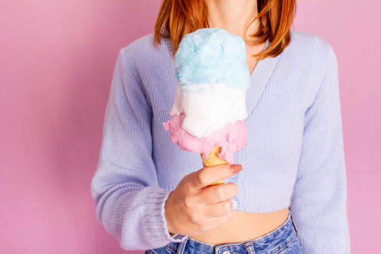 Midsection of young woman holding ice cream