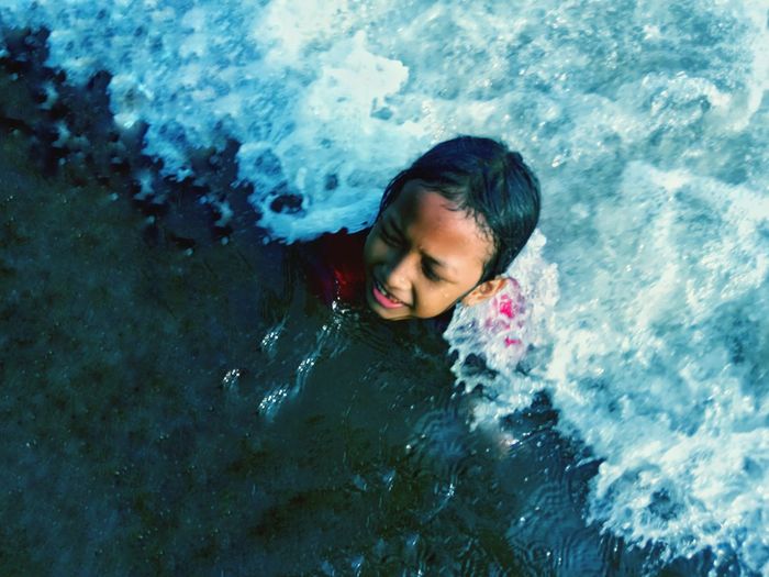 High angle view of girl swimming in sea
