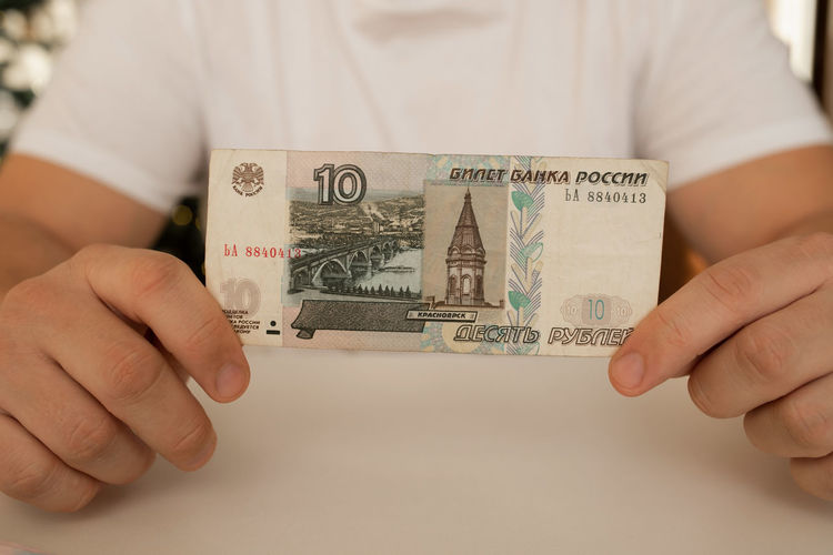 Midsection of person holding paper currency