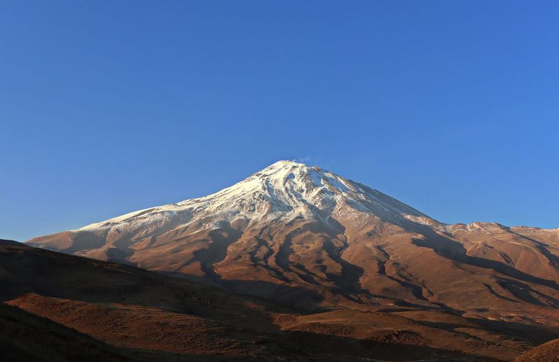 Scenic view of snowcapped mountains against clear blue sky. damavand mountian