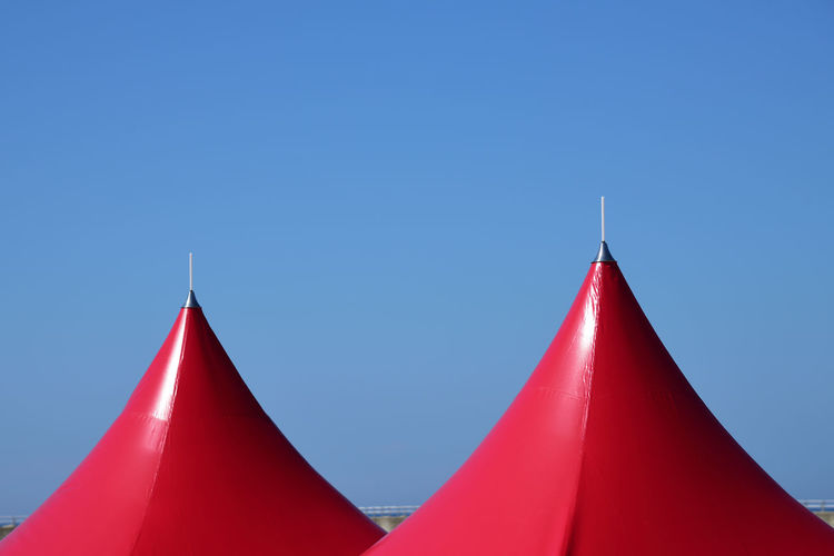 Low angle view of red building against blue sky