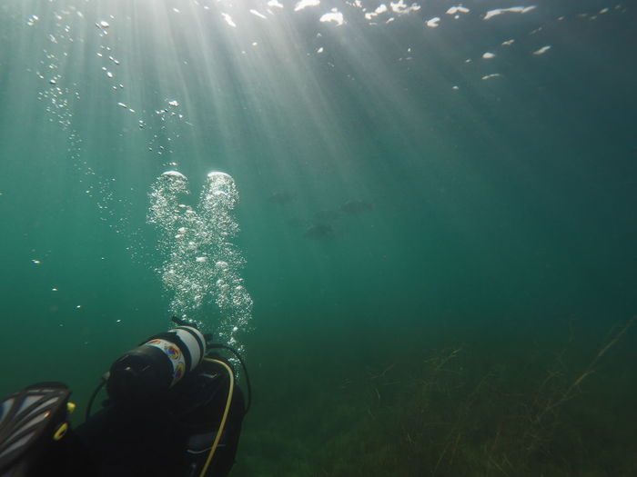 Sunbeams underwater with a scubadiver