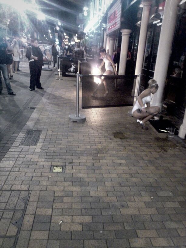 PEOPLE IN ILLUMINATED CITY AT NIGHT