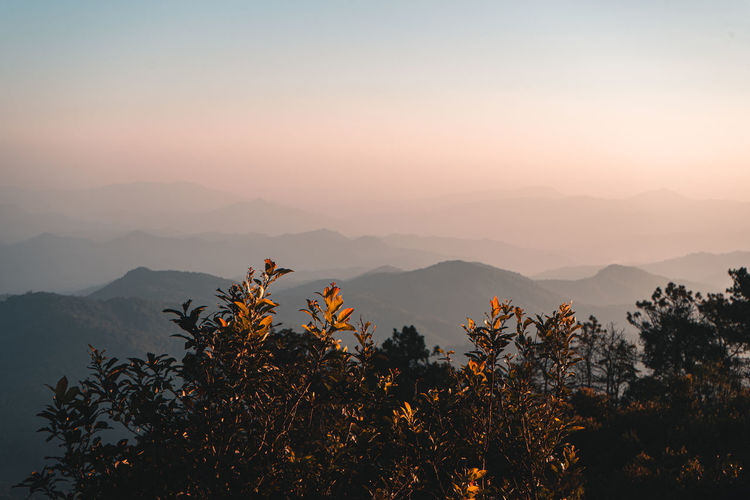 Scenic view of silhouette mountains against sky at sunset