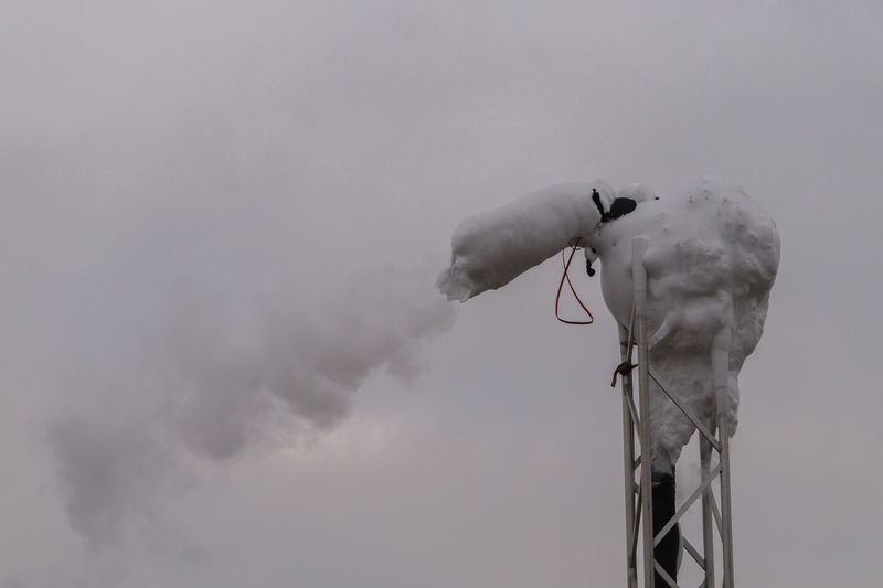 Frozen smoke stack emitting pollution