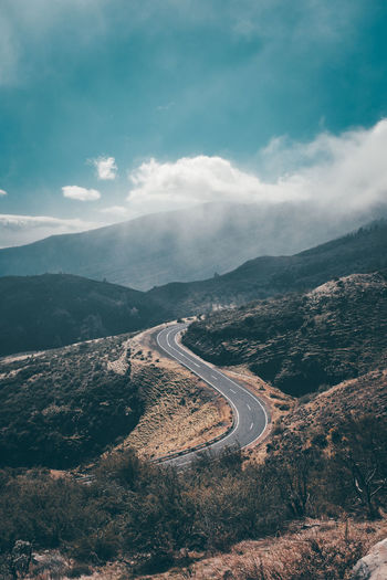 Aerial view of mountain road against cloudy sky