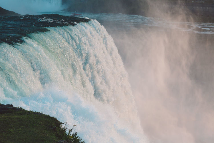 Scenic view of waterfall against sky