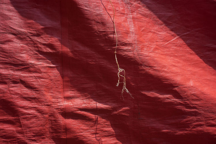Full frame shot of red tarpaulin during sunny day