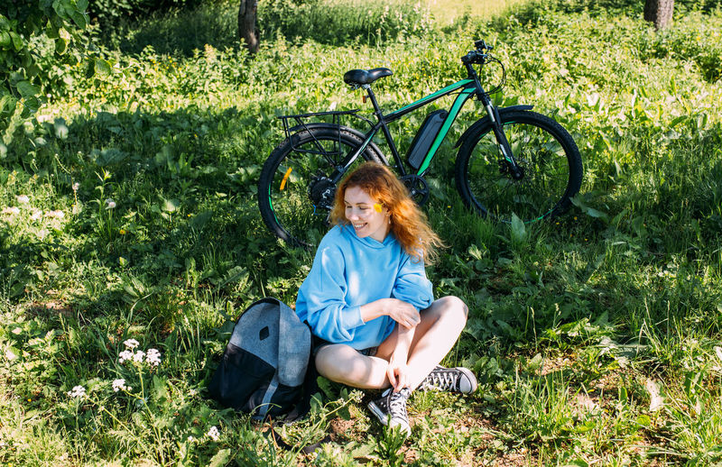 A young woman uses a modern electric bicycle for sports and outdoor recreation