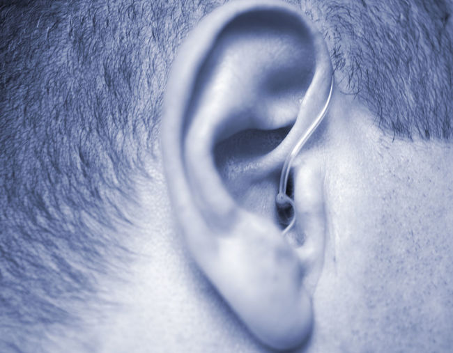 Close-up of man with hearing aid