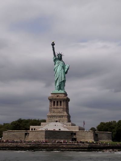 Statue of liberty against cloudy sky