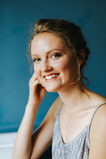 Portrait of smiling young woman at cafe