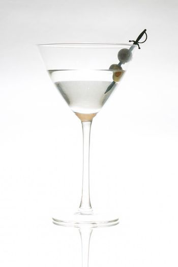 Close-up of wine in glass against white background