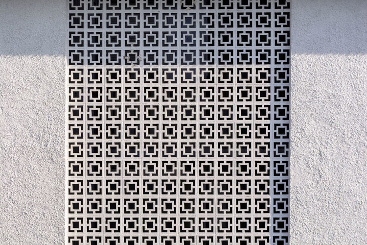 Full frame shot of patterned window amidst wall
