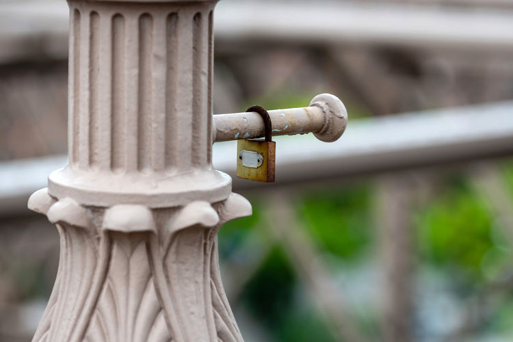 Close-up of padlock on architectural column