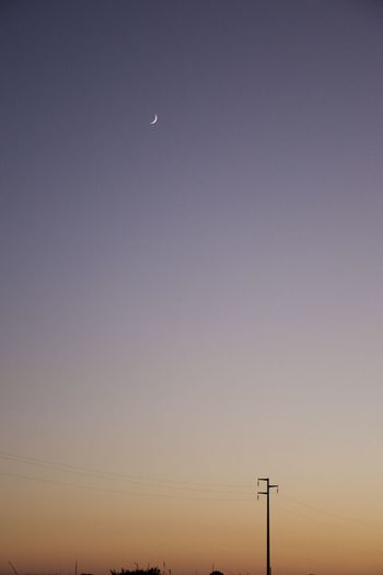 Low angle view of street light against clear sky during sunset