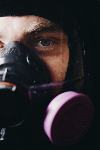 Close-up portrait of man wearing gas mask