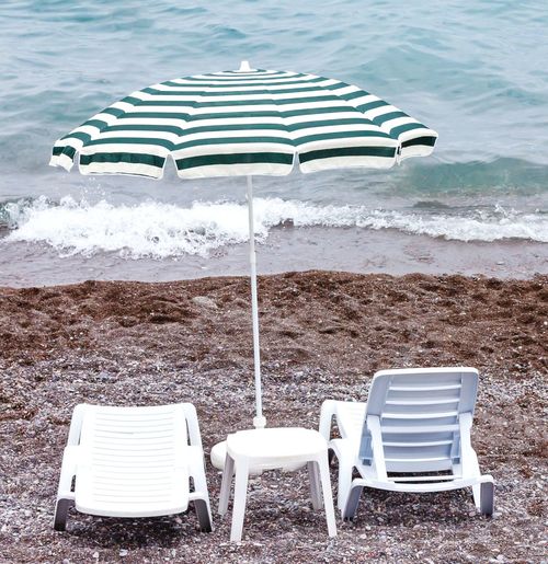 Empty deck chairs on beach