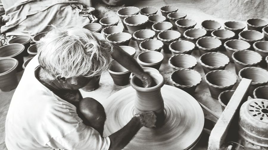 High angle view of potter making pots at workshop