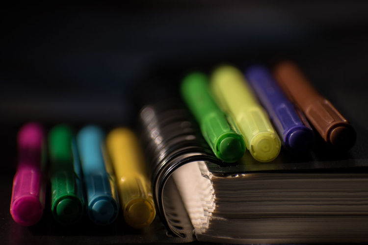 Close-up of multi colored felt tip pens with diary
