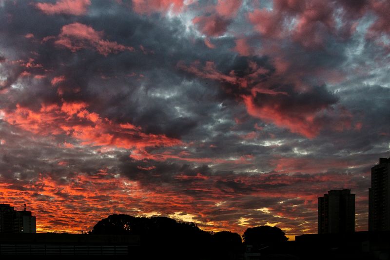 Silhouette of buildings against dramatic sky