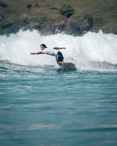 Man surfing in sea, lombok surfing. 