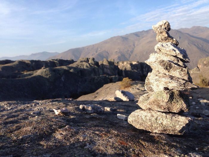 Close-up of stacked rocks against mountains