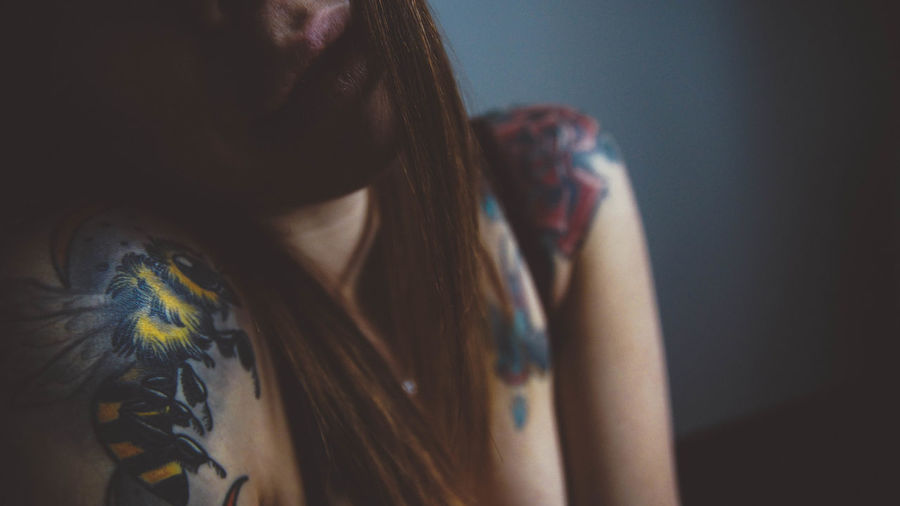 Woman with multi colored tattoos