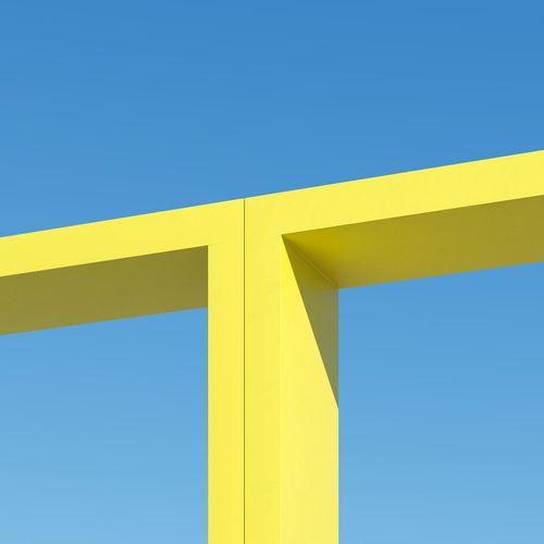 Yellow shape building with shadows on sky background. minimal architecture ideas concept. 3d render.