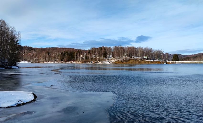 Scenic view of frozen lake against sky during winter