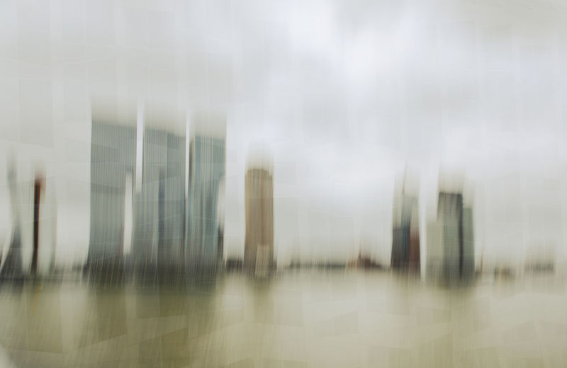 Digital composite image of modern glass building in city