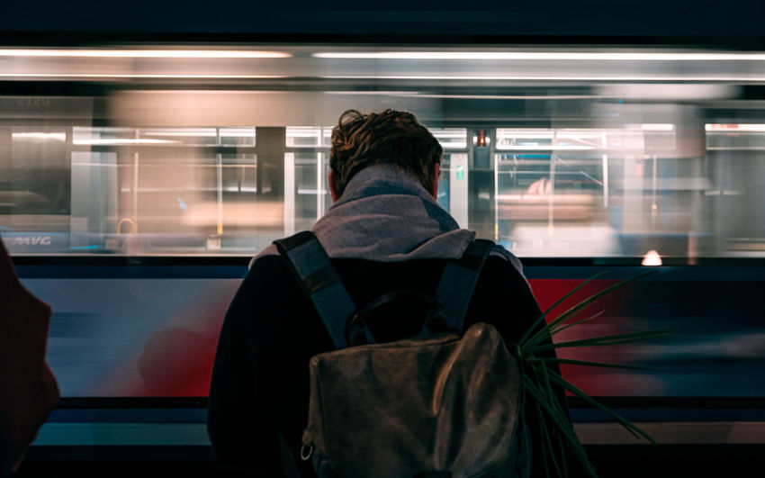 Rear view of man waiting for train train