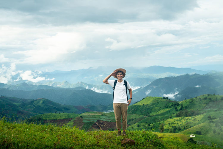 Man standing by mountains against sky