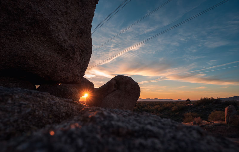 Sunrise peeks through opening in boulders