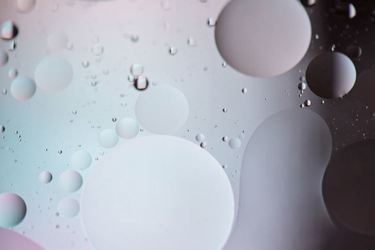Oil drops in water. defocused abstract psychedelic pattern image light blue colored. dof.