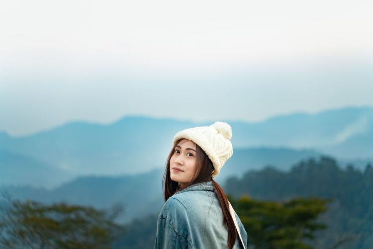Smiling woman against mountains