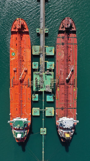 Directly above shot of cargo ships moored by offshore platform 