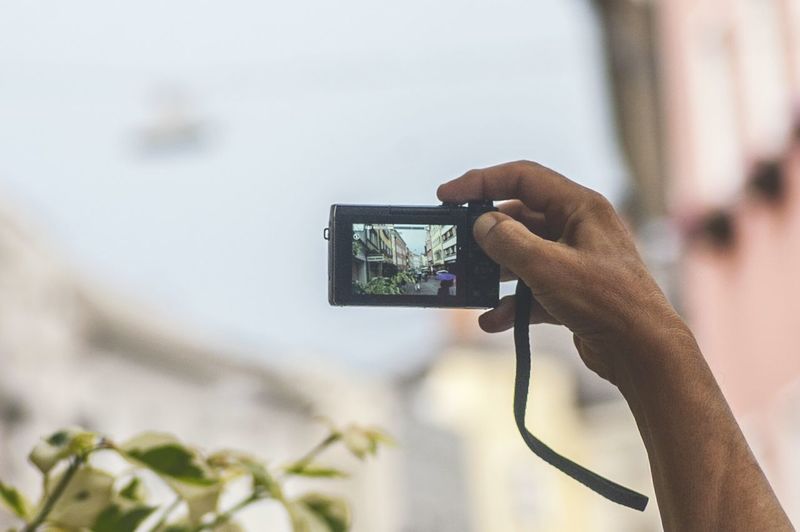 Close-up of hand holding camera