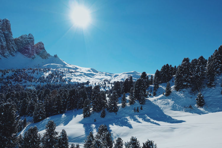 Scenic view of snowcapped mountains against clear blue sky
