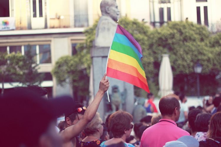 Crowd with rainbow flag during gay pride parade