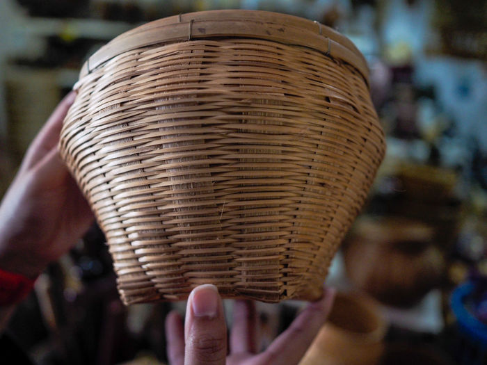 Close-up of hand holding wicker basket
