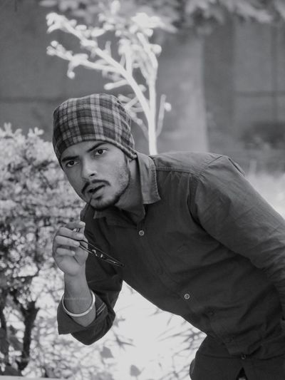 Portrait of young man standing outdoors