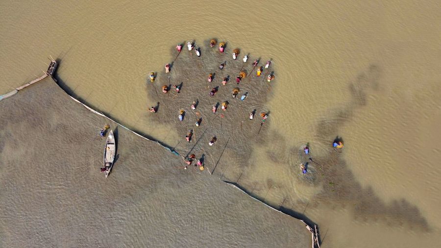 High angle view of people on sand on field