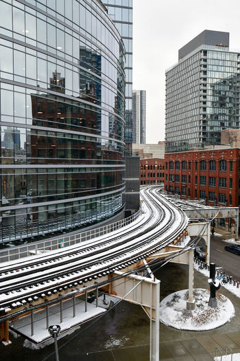 Urban elevated commuter train tracks through the city in winter
