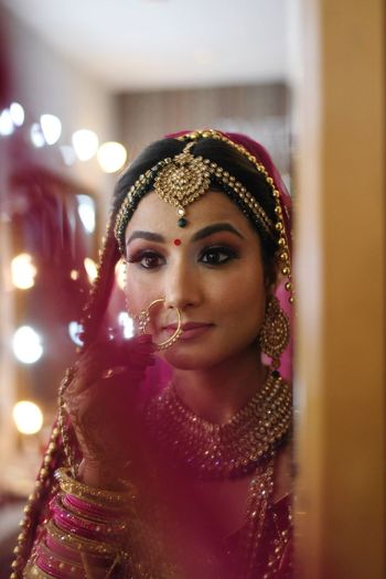 Bride looking at mirror during wedding ceremony