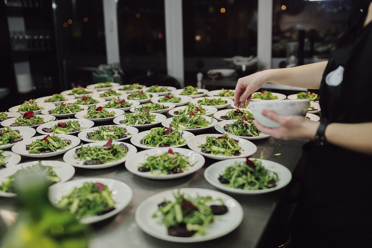 Midsection of chef preparing food at hotel