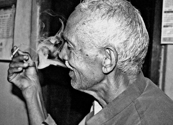 Close-up of senior man smoking cigarette