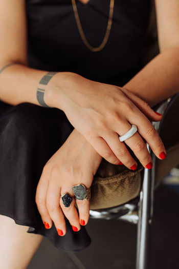 Close up of female hands with red nail polish and rings