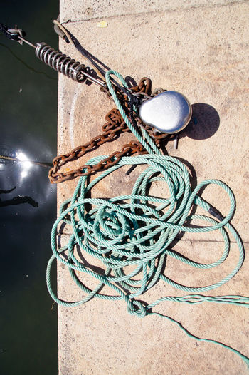 High angle view of rope tied to metal