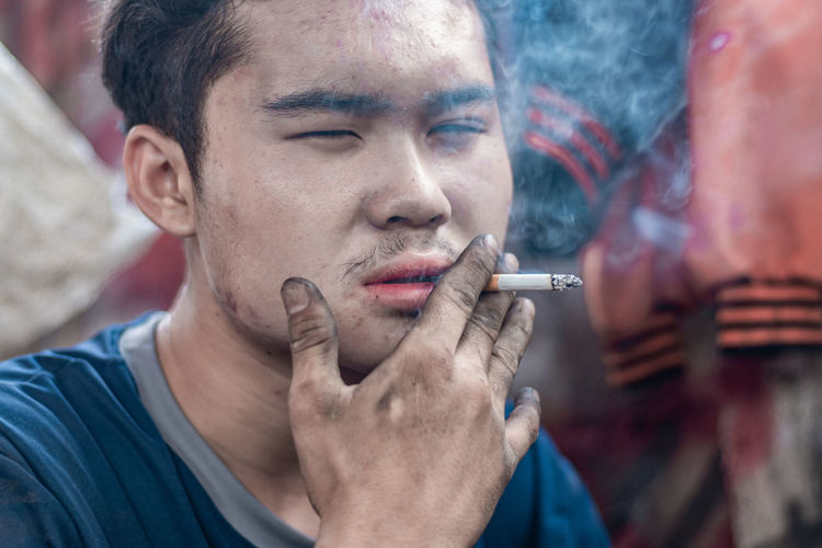 Close-up of man smoking outdoors